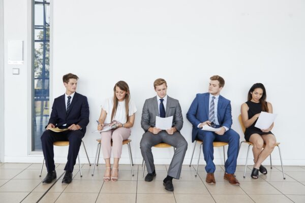 Candidates waiting for job interviews, full length, front