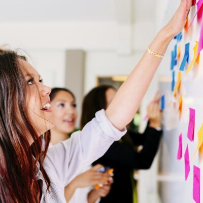 Business people fixing sticky notes at office