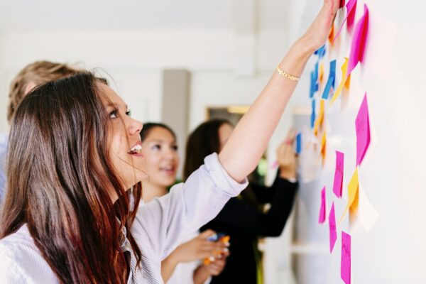 Business people fixing sticky notes at office